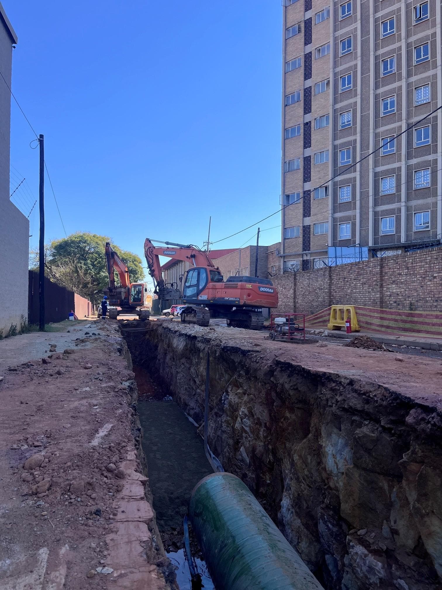 Doosan excavators working a deep pipeline trench on the Crosby bulk-water contract