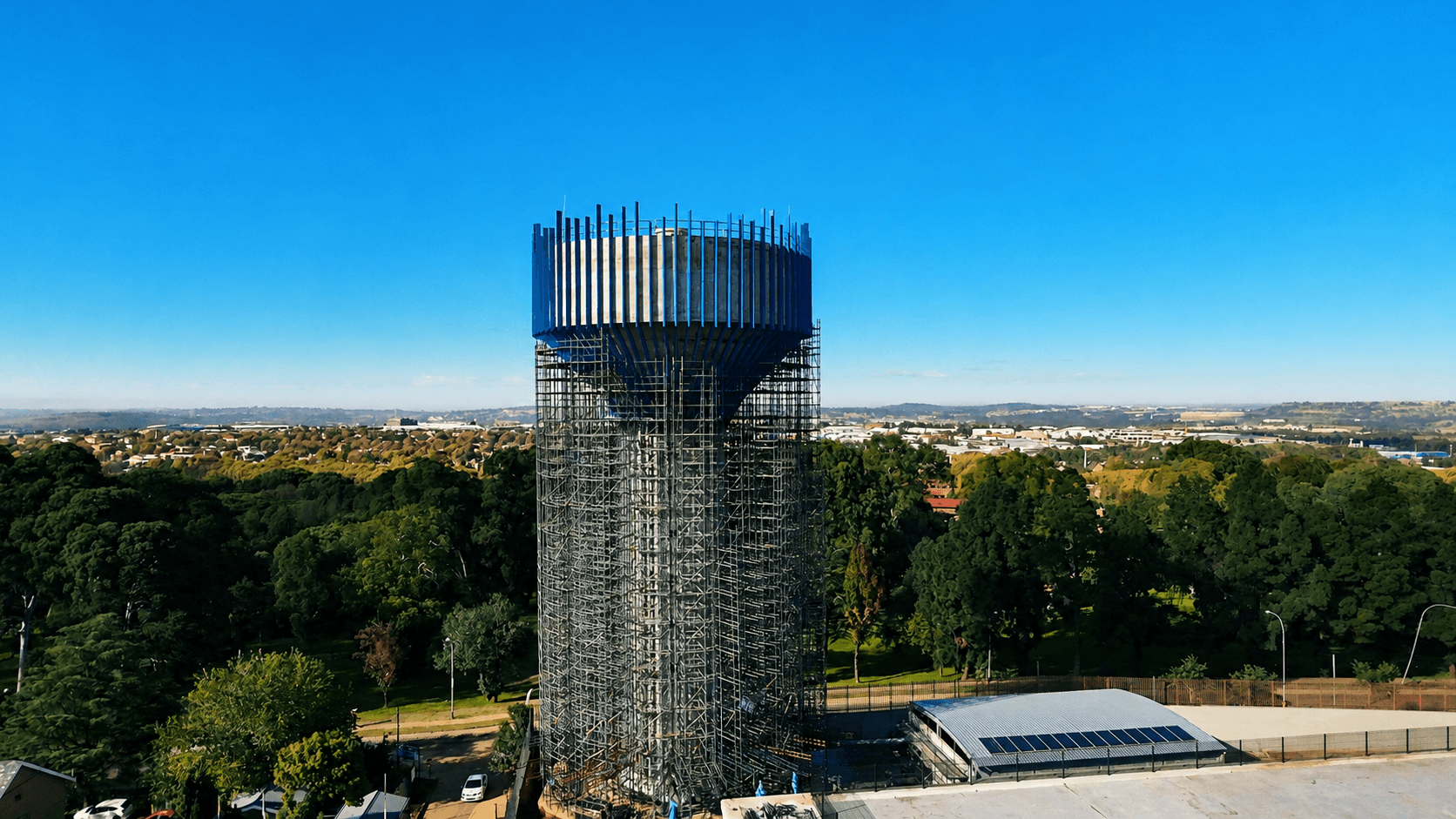 Brixton water tower under construction above the Johannesburg landscape